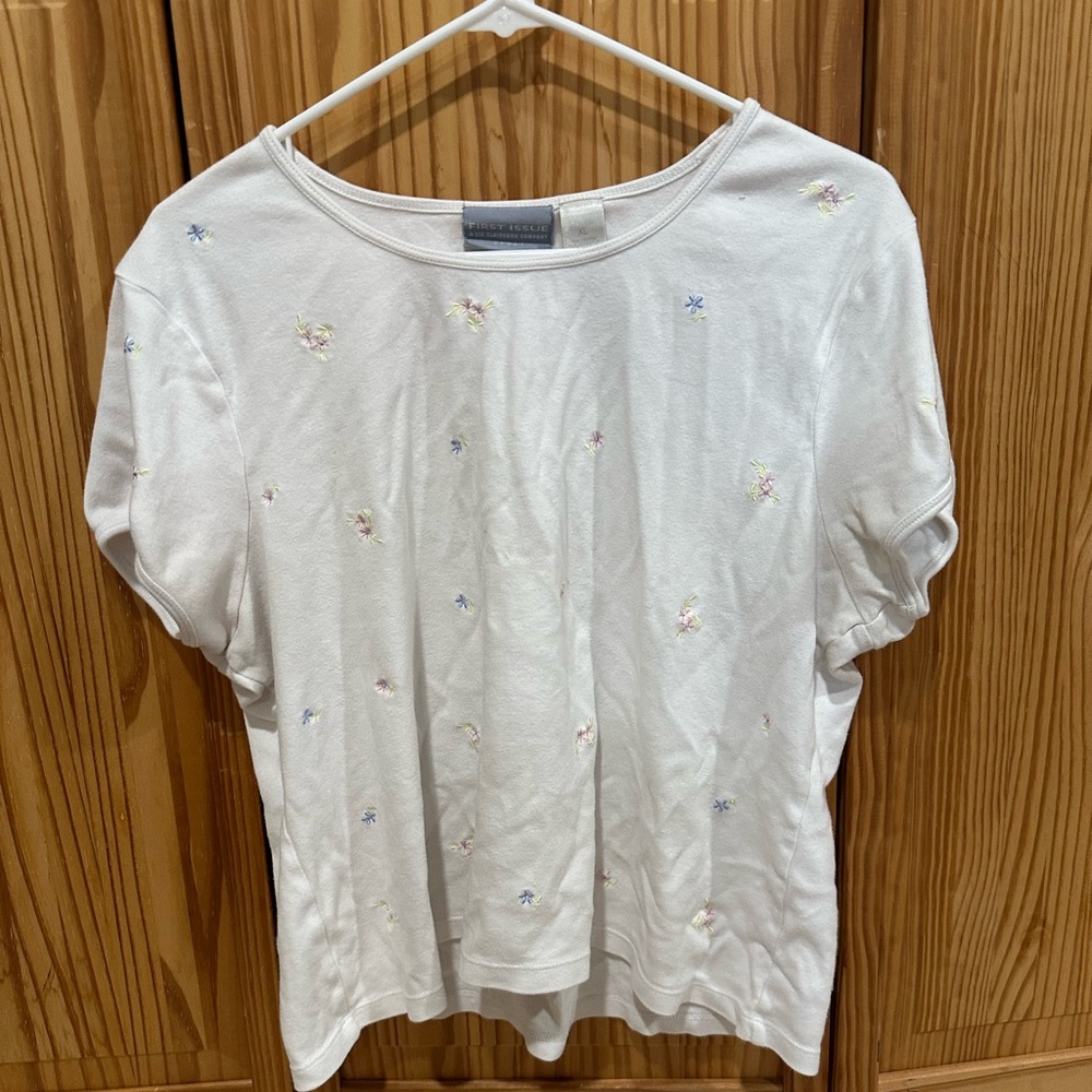 A white cropped top with mine flowers